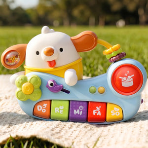 Colorful children's toy piano with a dog design on a grassy background