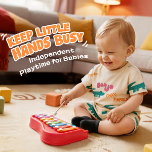 Baby playing with a colorful toy piano in a living room setting.